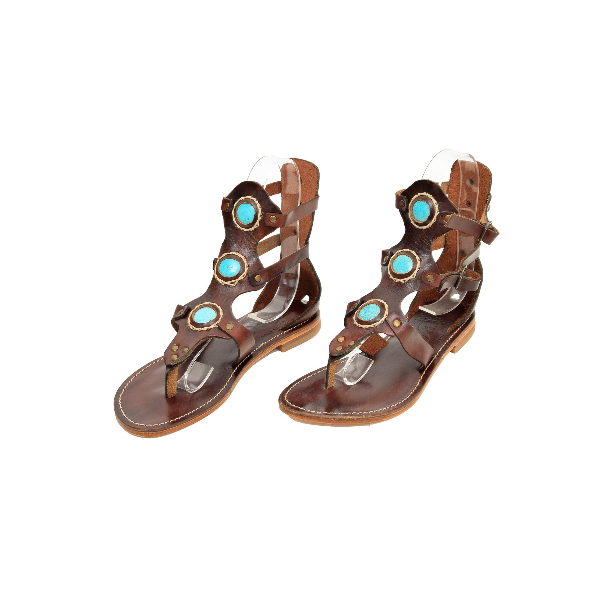 a pair of brown leather sandals with turquoise stones