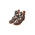 a pair of brown leather sandals with turquoise stones